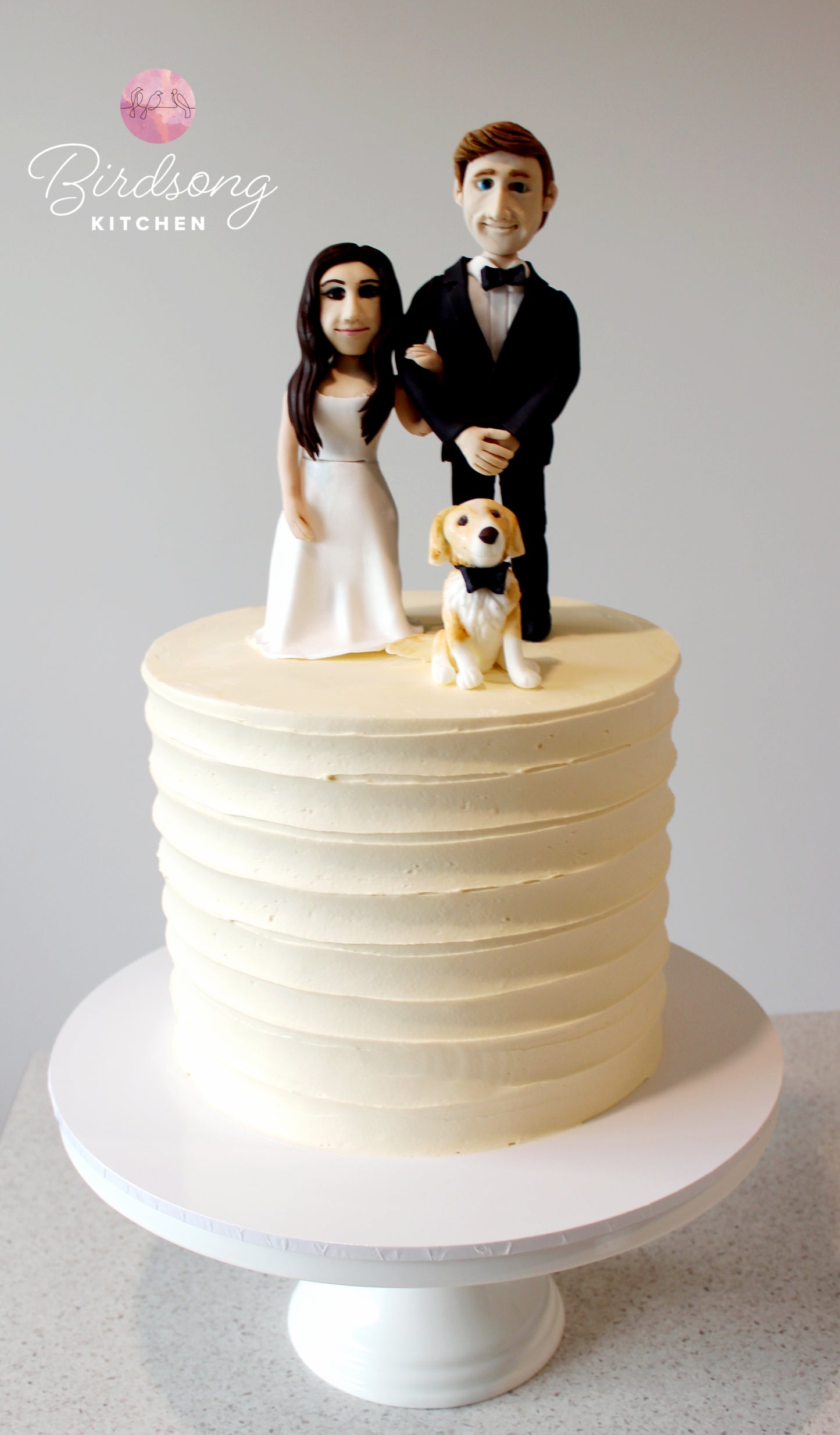 Handmade bride and groom figurine wedding cake