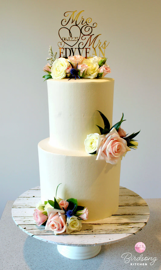 Elegant tiered cake with fresh flowers